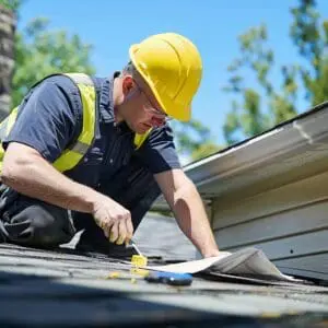 Emergency roof leak solutions with a contractor inspecting water damage